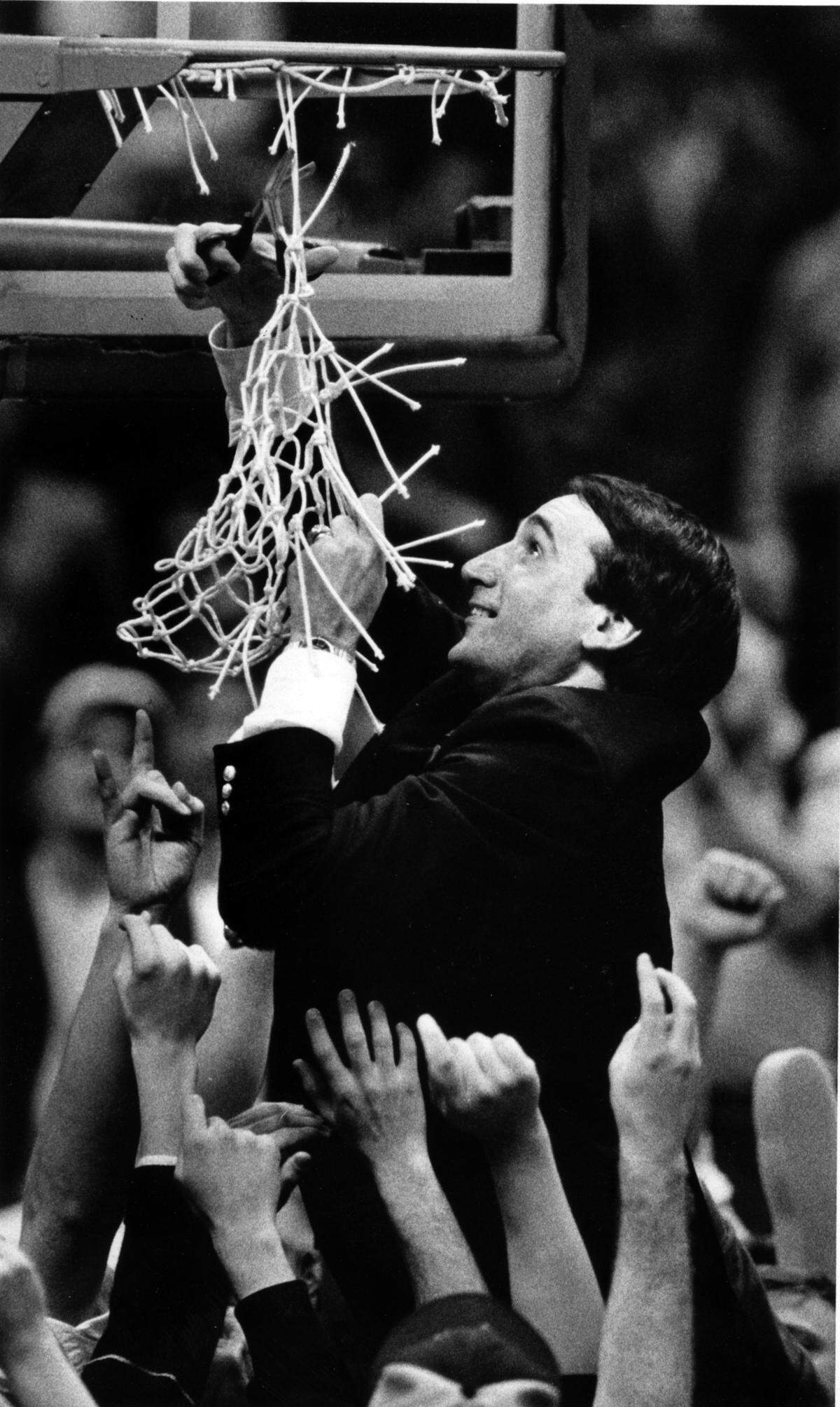 Duke coach Mike Krzyzewski cuts down the net after the Blue Devils win the 1986 ACC Tournament by defeating the Georgia Tech Yellow Jackets 68-67 in Greensboro. 