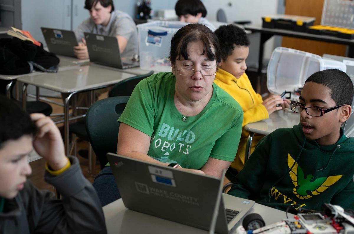 Volunteer Mary Ann Miller works with sixth-grader Landon Wallace in an after-school robotics club on Thursday, January 30, 2020 at Wake Young Men’s Leadership Academy in Raleigh, N.C.