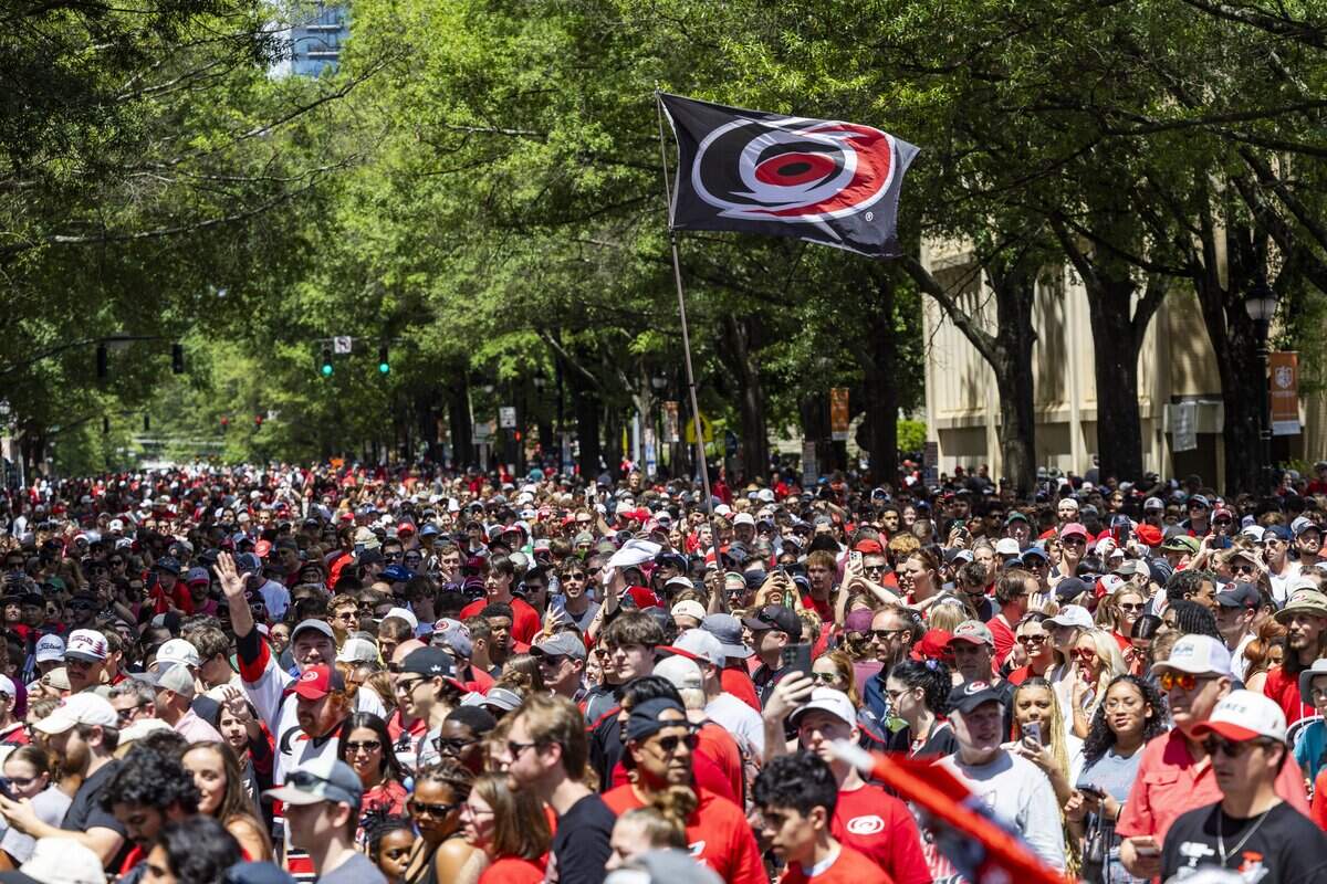 Thousands of Carolina Hurricanes fans gather in downtown Raleigh on Saturday, June 20, 2026, during a parade and rally celebrating the Hurricanes' Stanley Cup Final victory over the Vegas Golden Knights. The Hurricanes won the series 4-2 to capture the Stanley Cup for the second time since 2006.