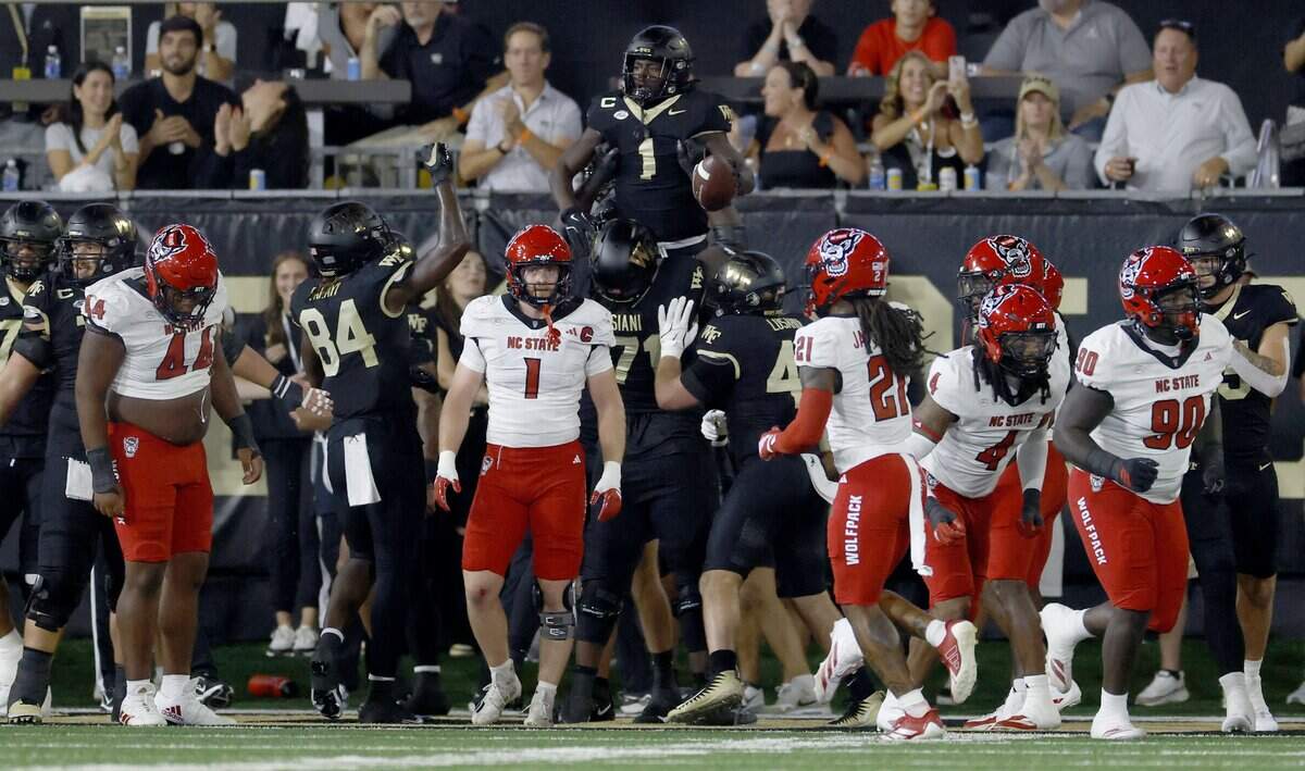 Wake Forest running back Demond Claiborne (1) is lifted up after scoring a touchdown in the first half of N.C. State’s game against Wake Forest at Allegacy Stadium in Winston-Salem, N.C., Thursday, Sept. 11, 2025.
