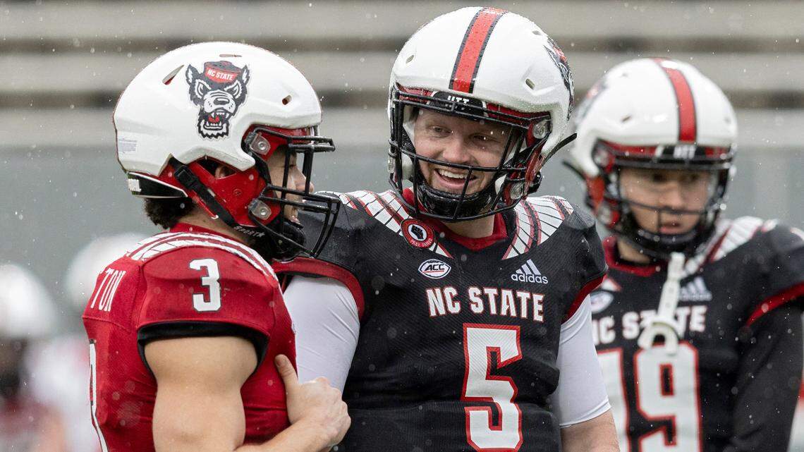 Brennan Armstrong, center, smiles while talking with Jordan Houston prior to N.C. State football’s spring game at Carter-Finley Stadium on Saturday, April 8, 2023, in Raleigh, N.C.