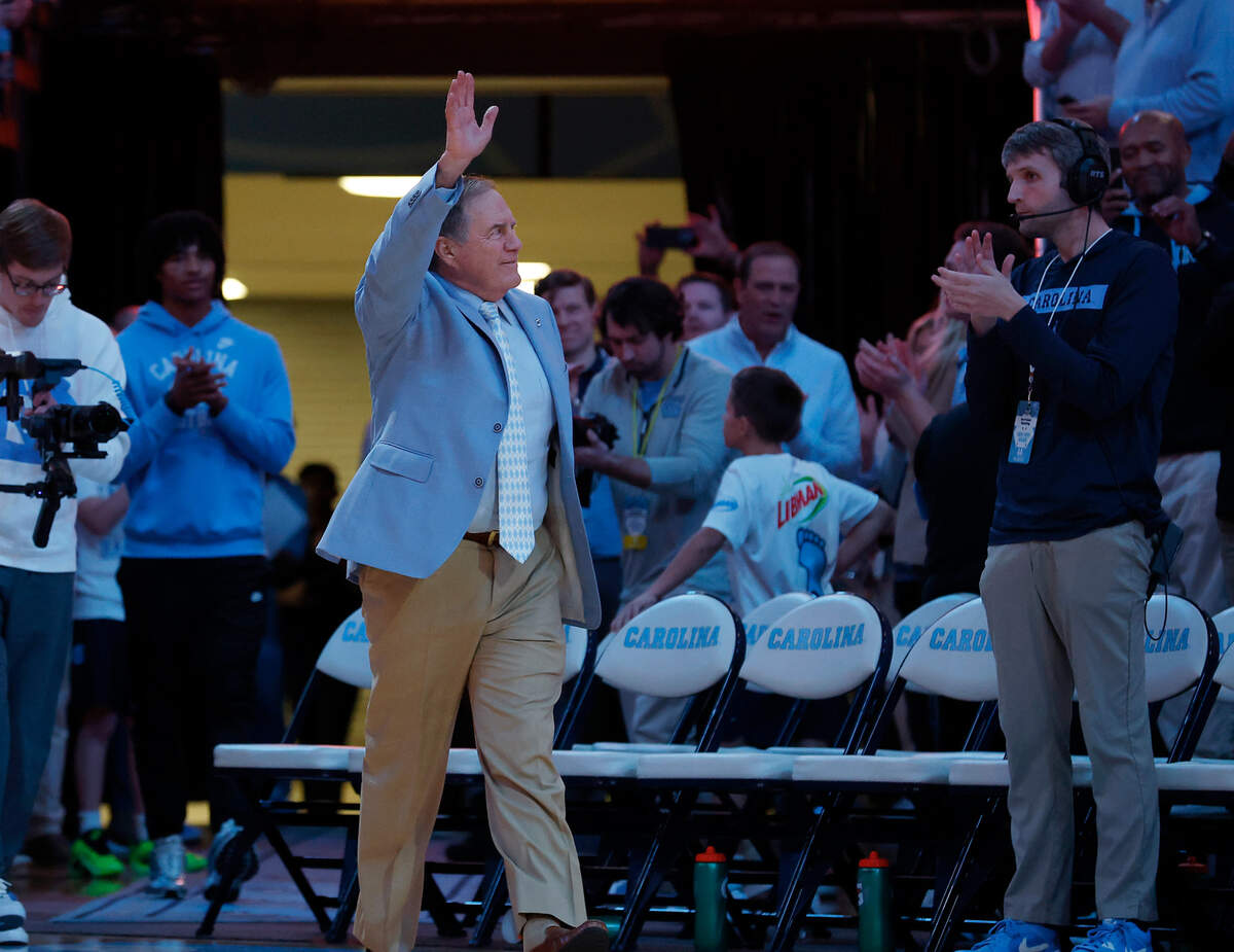 Recently hired North Carolina football coach Bill Belichick acknowledges the crowd as he is introduced during halftime of the Tar Heels’ men’s basketball game against La Salle on Saturday, Dec. 14, 2024, at the Smith Center in Chapel Hill, N.C.