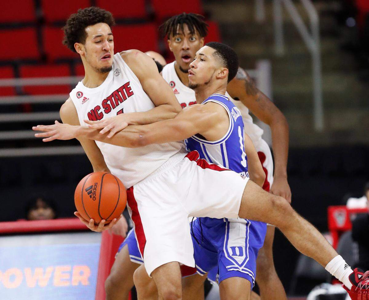 Duke’s Jordan Goldwire (14) fouls N.C. State’s Jericole Hellems (4) during the second half of Duke’s 69-53 victory over N.C. State at PNC Arena in Raleigh, N.C., Saturday, February 13, 2021.