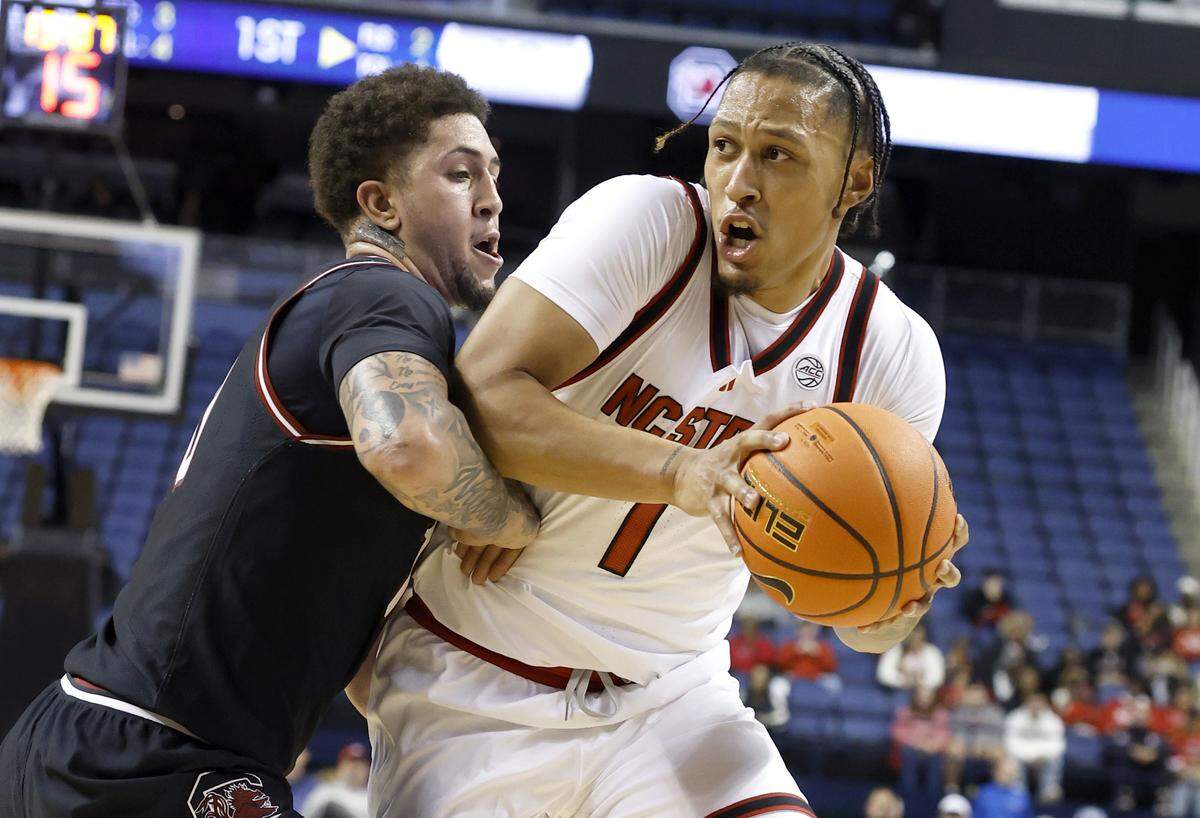 N.C. State's Darrion Williams (1) drives around South Carolina's Myles Stute (10) during an exhibition game on Oct. 26.