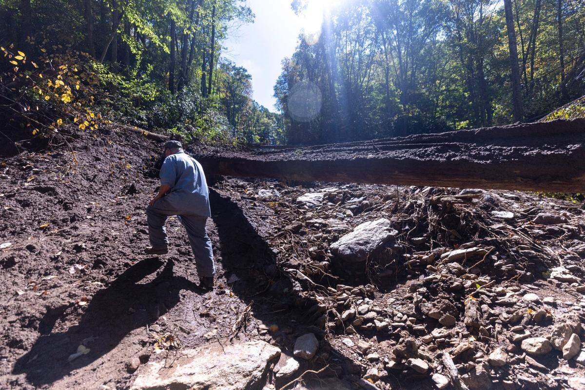 Dale Smith, 71, of Cruso surveys damage caused by a landslide on his property in Cruso on Saturday, October. 5, 2024. The remnants of Hurricane Helene caused more than 300 landslides, many in North Carolina.