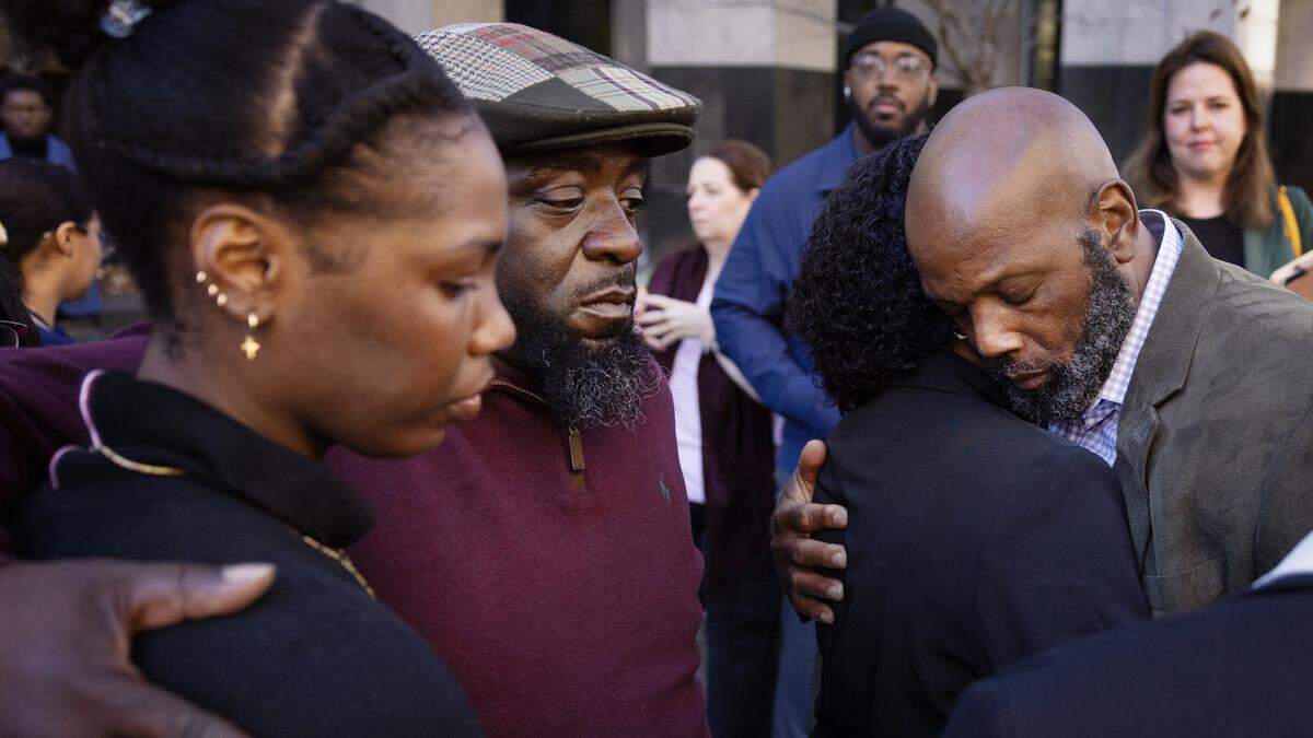 Family members of Benji Martin Jr. console each other following a press conference after Martin’s first appearance in Wake County court on charges of murder in the shooting death of WakeMed Garner police officer Roger Smith.  Martin’s father, Benji Martin, Sr., is at right.