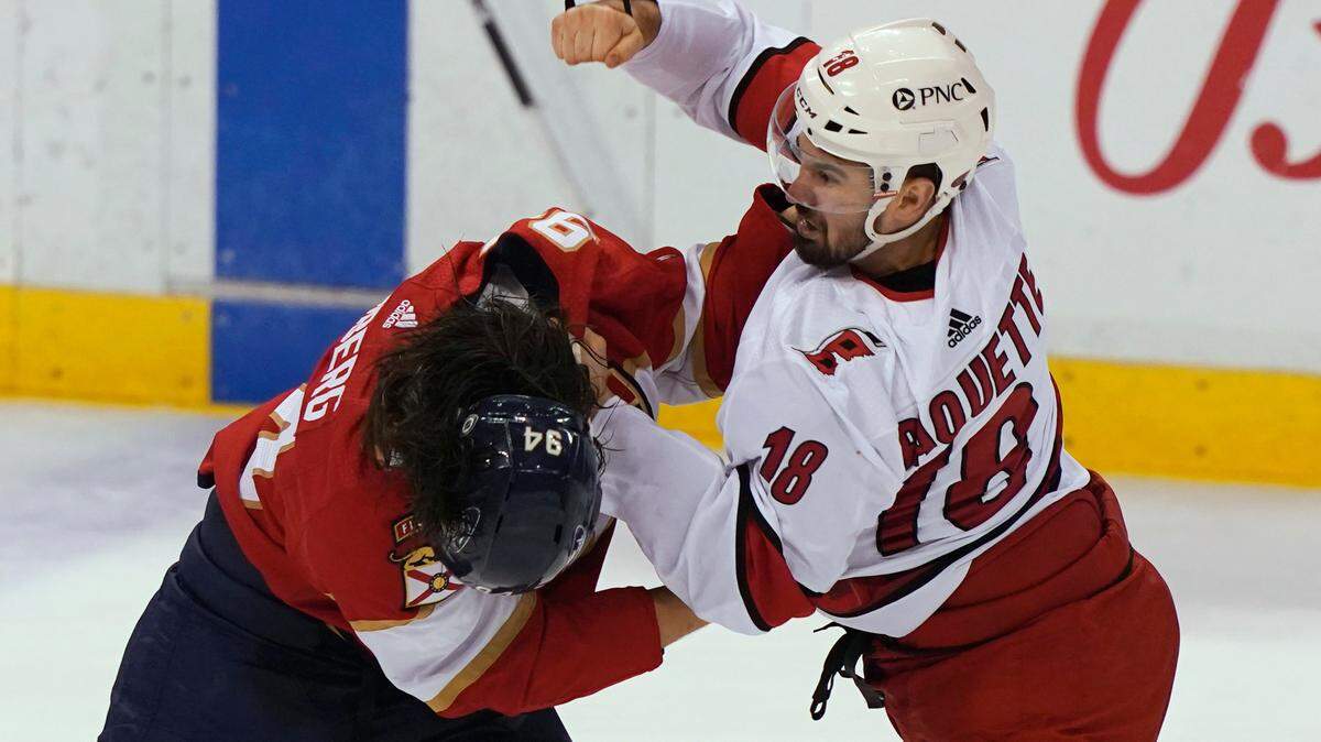 Carolina Hurricanes center Cedric Paquette (18) and Florida Panthers left wing Ryan Lomberg (94) fight during the first period at an NHL hockey game Thursday, April 22, 2021, in Sunrise, Fla. (AP Photo/Marta Lavandier)
