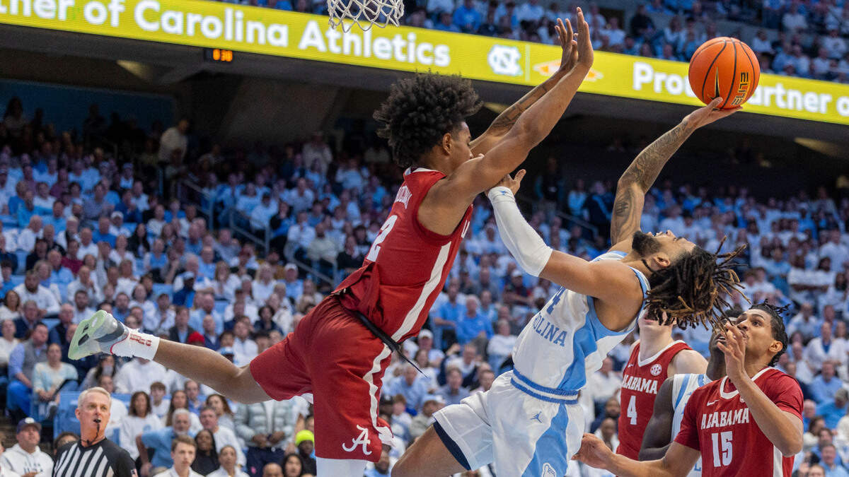 Alabama guard Aden Holloway (2) defends North Carolina guard R.J. Davis (4) in the second half on Wednesday, December 4, 2024 at the Smith Center in Chapel Hill, N.C.