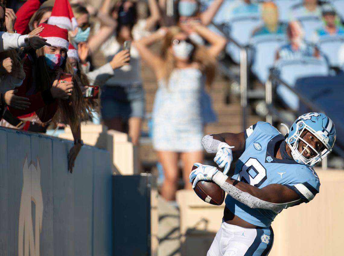 North Carolina’s Michael Carter (8) celebrates after scoring on a 46-yard pass from quarterback Sam Howell in the fourth quarter against Wake Forest at Kenan Stadium on Saturday, November 14, 2020 in Chapel Hill, N.C.