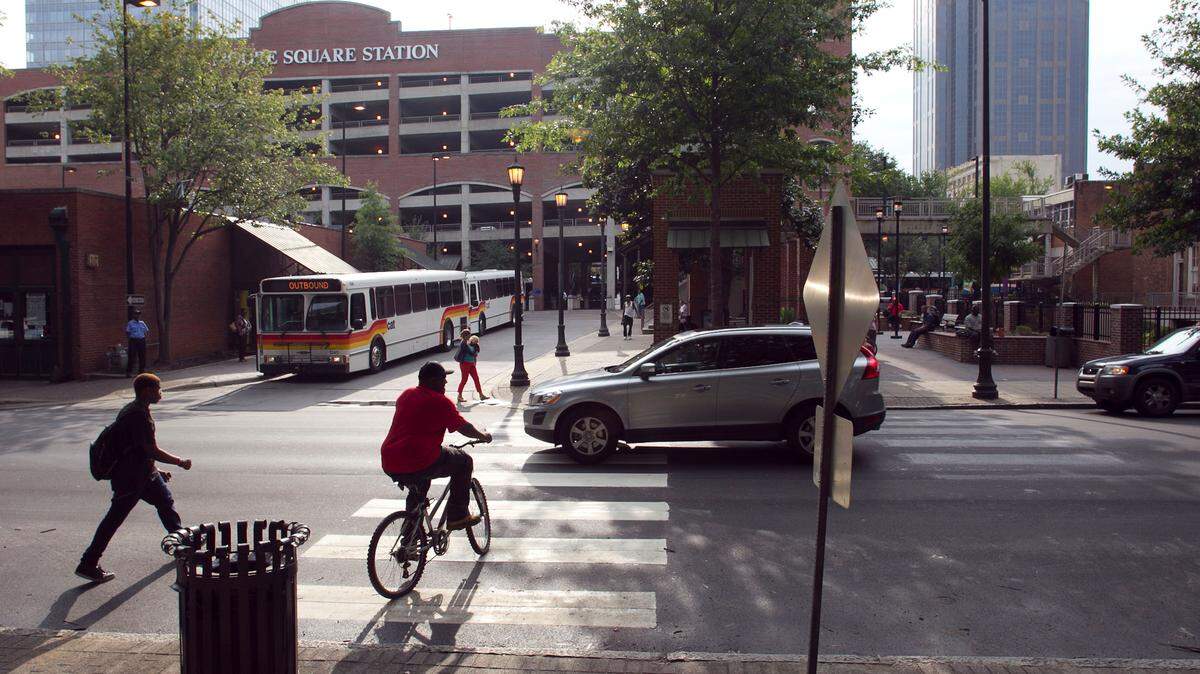 Pedestrians use a crossing on Blount Street on their way to the The Moore Square Bus Terminal in downtown Raleigh during the afternoon rush hour on Tuesday August 21, 2012 in Raleigh, N.C.