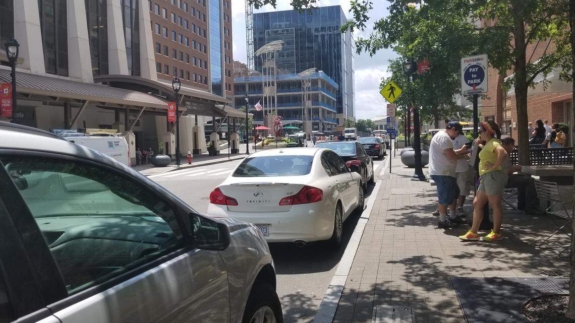 Drivers pay for on-street parking in downtown Raleigh on Aug. 17, 2018.