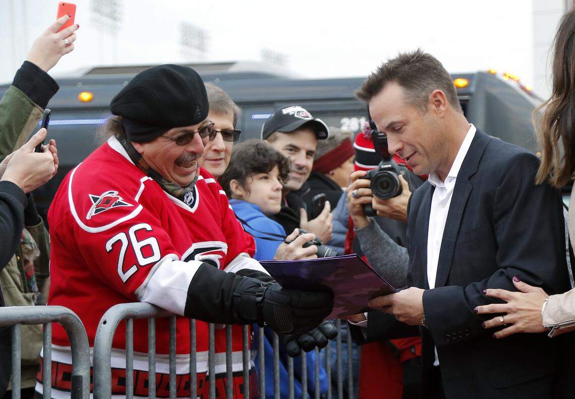 Ray Whitney signs an autograph for a happy fan as he walks in to a red carpet reception held before an NHL game played between the Carolina Hurricanes and the Pittsburgh Penguins at the PNC Arena in Raleigh, N.C. on 2016 when the Canes celebrated the 10th anniversary of their Stanley Cup championship.