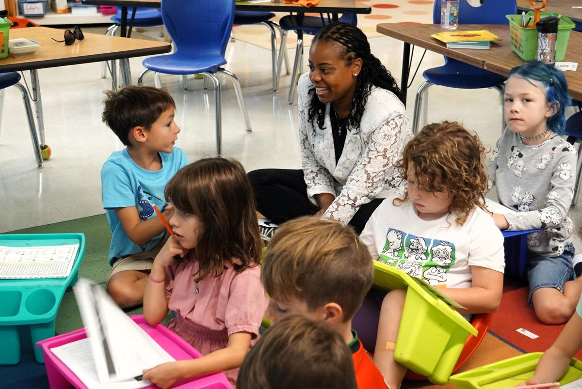 Chapel Hill-Carrboro Superintendent Nyah Hamlett talks with elementary school students in this undated district photo. Hamlett, who was hired in January 2021, announced she will leave the district in June 2025.