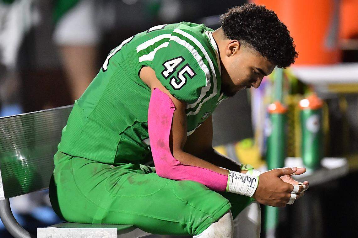 Cary tight end Donald Haley Jr. (45) reflect on the bench after the plays by Middle Creek during the first half.  The Cary Imps and the Middle Creek Mustangs met in a conference football game in Cary, N.C. on October 24, 2025
