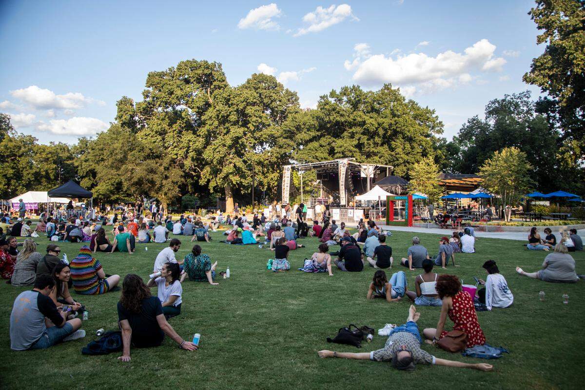 Concert-goers listen to Parquet Courts play Moore Square in Raleigh during the third day of the Hopscotch Music Festival Saturday, Sept. 11, 2021.
