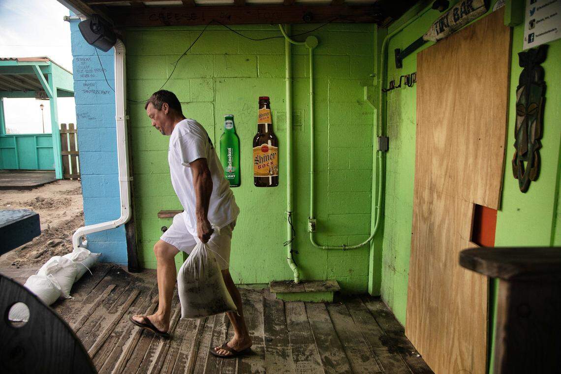 Morehead City Mayor Pro Tempore Richard Porter places sandbags around the Tackle Box Tavern in Atlantic Beach. The bar which boasts that it stays open 365 days per year closed its doors Wednesday, Sept. 12, 2018 in anticipation of Hurricane Florence.