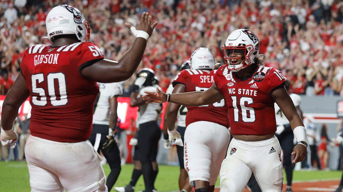 N.C. State quarterback MJ Morris (16) celebrates with Grant Gibson (50) after throwing a 1-yard touchdown to wide receiver Darryl Jones during the second half of N.C. State’s 30-21 victory over Wake Forest at Carter-Finley Stadium in Raleigh, N.C., Saturday, Nov. 5, 2022.