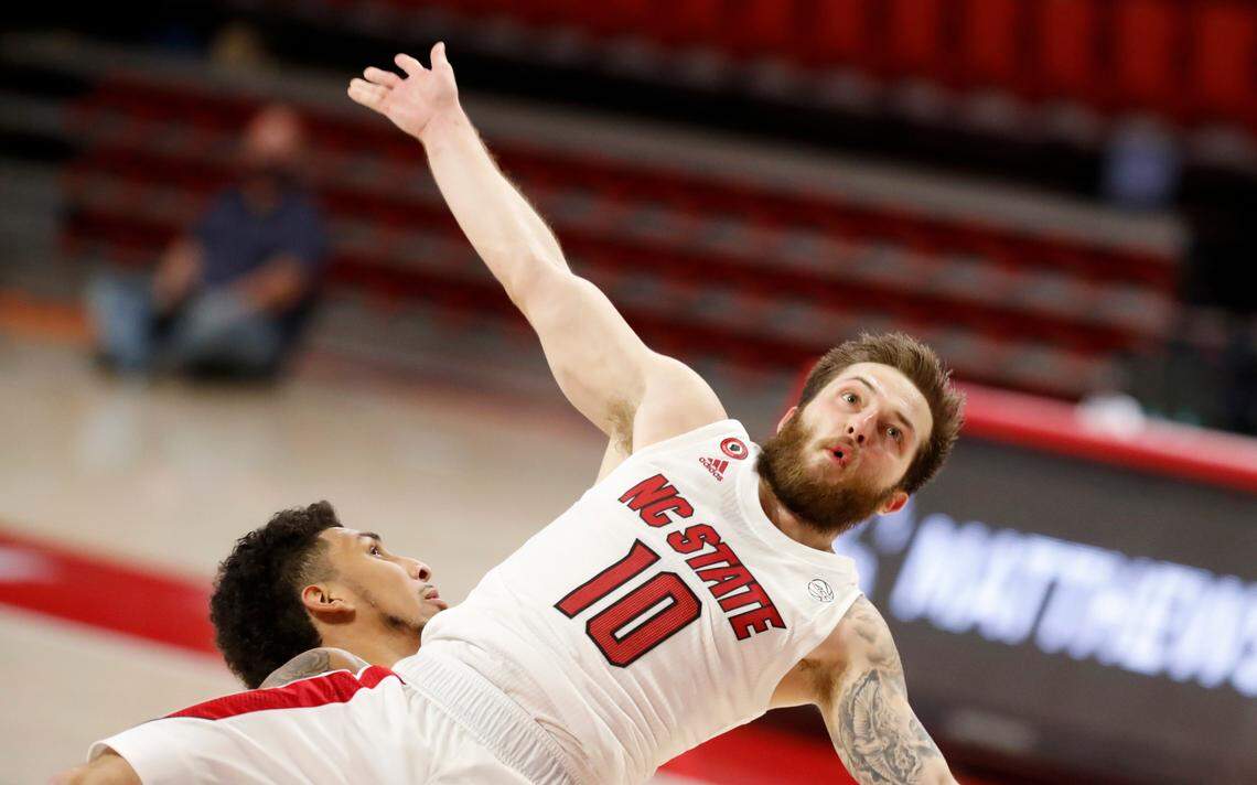 N.C. State’s Braxton Beverly (10) goes flying after being fouled by Charleston Southern’s Sean Price (23) during the second half of N.C. State’s 95-61 victory over Charleston Southern in the Wolfpack Invitational at Reynolds Coliseum in Raleigh, N.C., Wednesday, Nov. 25, 2020.
