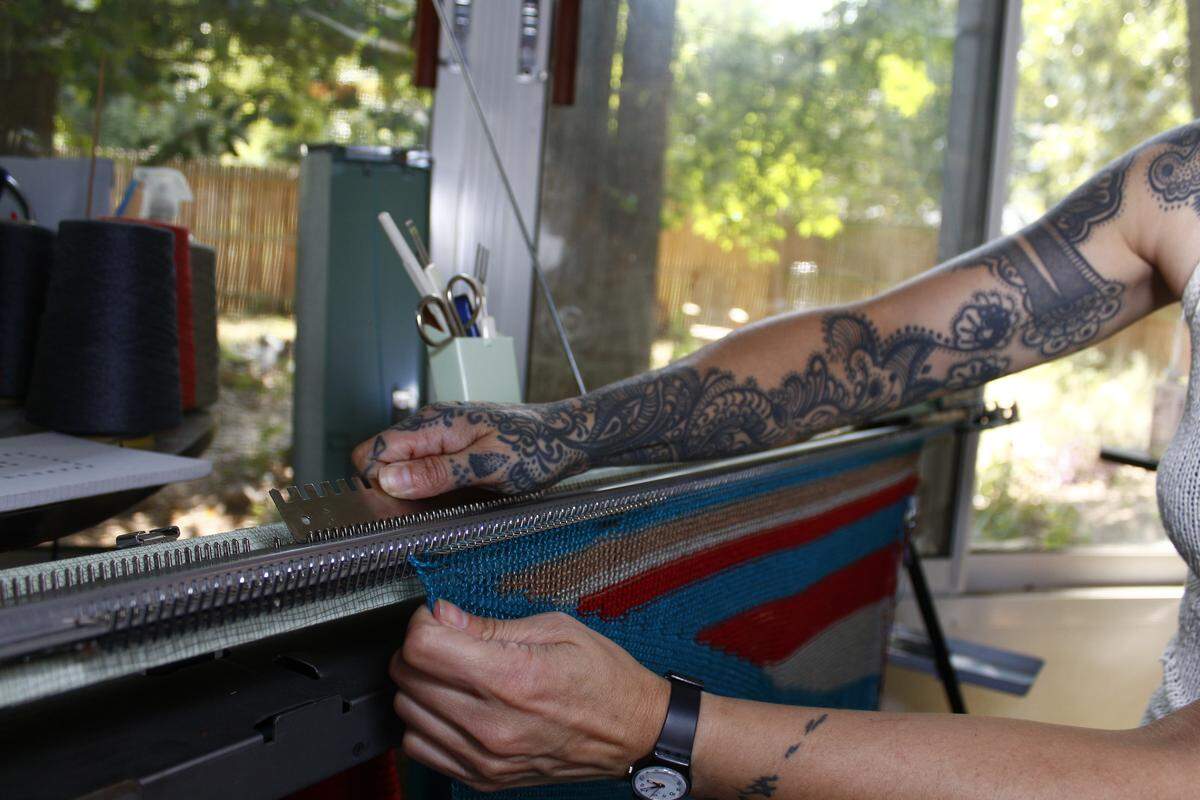 Eris Swanstrom uses vintage knitting machines to make sweaters, legwarmers and more for her knitwear line,  Modique Couture. She uses  yarn made with American-sourced fibers and hand-dyed at Debbie Duck Yarns in Fuquay-Varina.