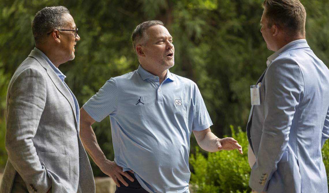 North Carolina basketball coach Michael Malone talks with former North Carolina quarterback Bryn Renner during a fundraiser for TABLE on Friday, April 17, 2026 in Carrboro, N.C.