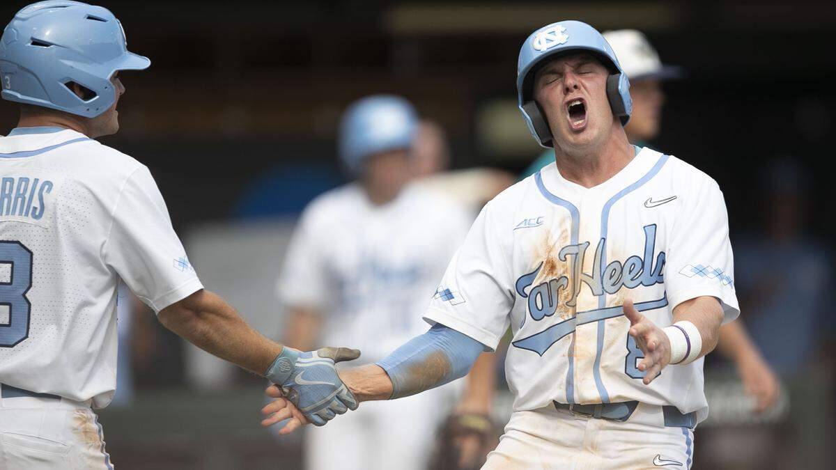 North Carolina’s Ike Freeman (8) celebrates with Dylan Harris (3) after scoring the go ahead run on a single by catcher Brandon Martorano (4) in the seventh inning against UNC-Wilmington during the NCAA Regional on Friday May 31, 2019 at Boshamer Stadium in Chapel Hill, N.C. The Tar Heels took a 5-4 lead in the seventh inning.
