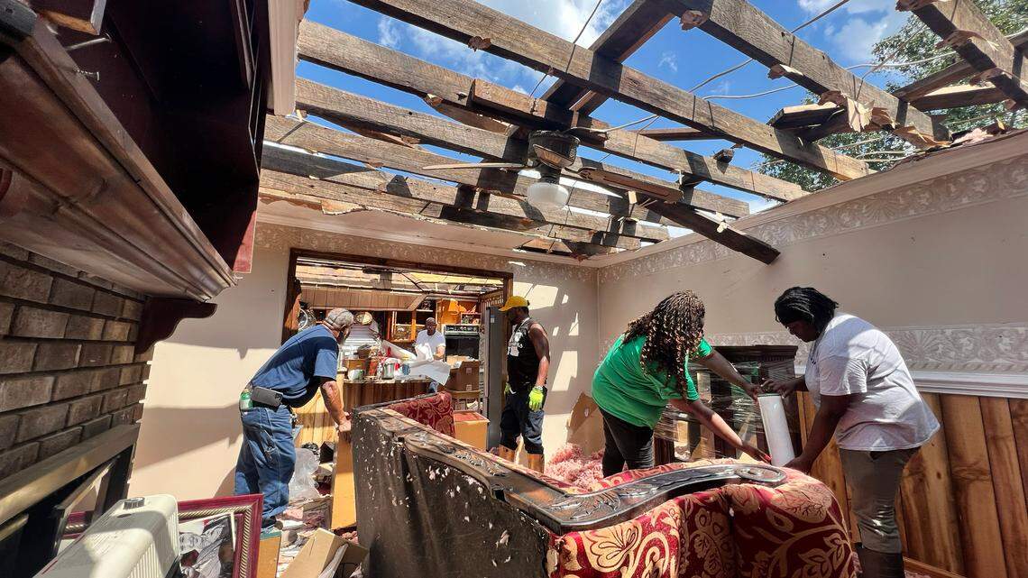 Friends and family try to salvage items from the home Evelyn Powell near Battleboro, N.C., Thursday, July 20, 2023. An EF-3 tornado hit the area Wednesday, heavily damaging or destroying several homes and businesses.