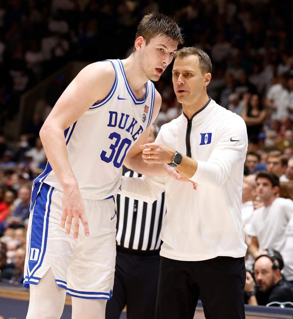 Duke head coach Jon Scheyer talks with Kyle Filipowski (30) during the second half of Arizona’s 78-73 victory over Duke at Cameron Indoor Stadium in Durham, N.C., Friday, Nov. 10, 2023.