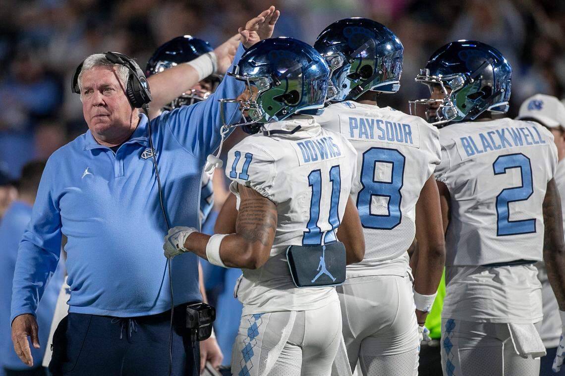 North Carolina coach Mack Brown gives Josh Downs (11) a pat on the head after the Tar Heels’ first touchdown drive on Saturday, October 15, 2022 at Wallace-Wade Stadium in Durham, N.C. Downs had nine catches for 126 yards in the Tar Heels’ victory.