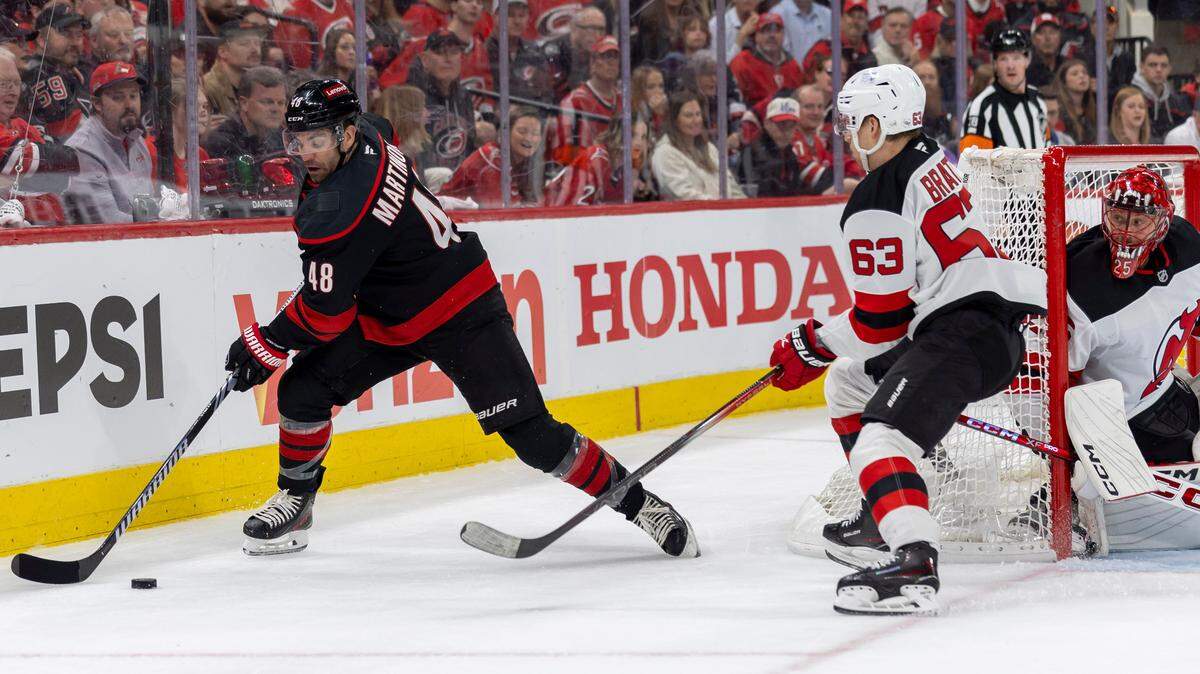 Carolina Hurricanes left wing Jordan Martinook (48) works behind New Jersey Devil’s goalie Jacob Markstrom (25) in the first period during game two of their Stanley Cup playoff series on Tuesday, April 22, 2025 at Lenovo Center in Raleigh, N.C.