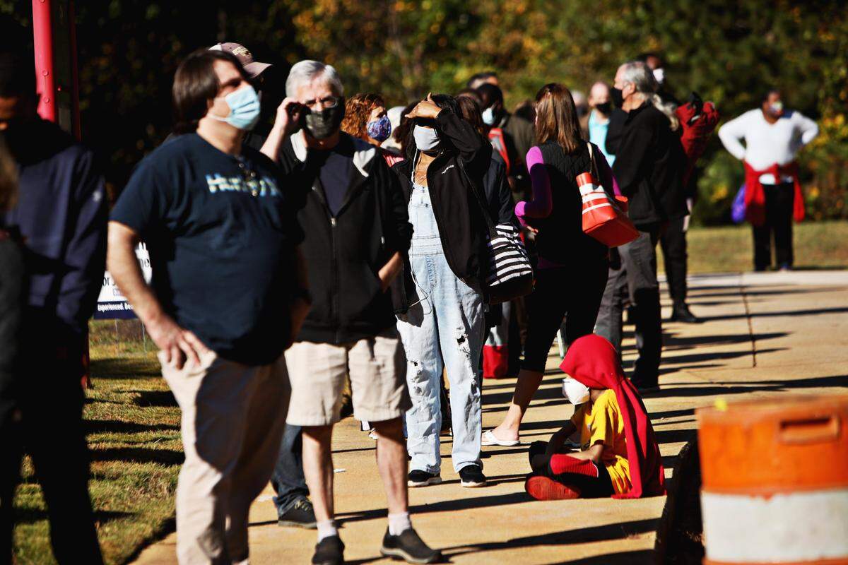 Voters stand in a long line for early voting at Lake Lynn Community Center in Raleigh on Thursday morning, Oct. 15, 2020.