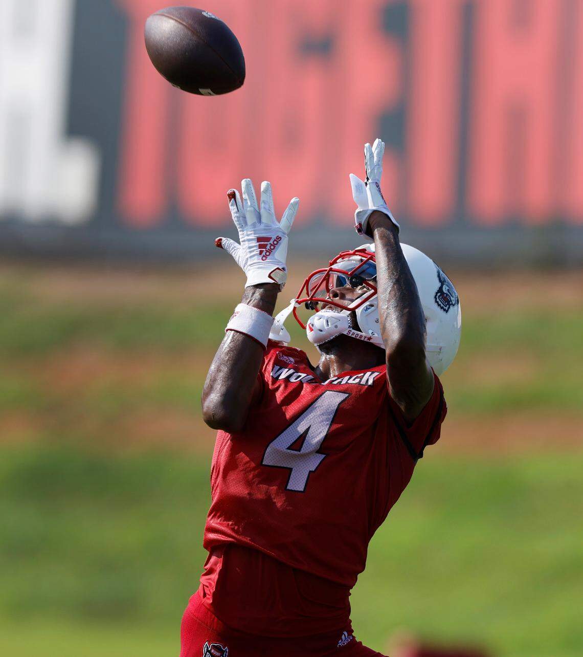 N.C. State wide receiver Dacari Collins (4) pulls in a pass during the Wolfpack’s first practice in Raleigh, N.C., Wednesday, July 31, 2024.