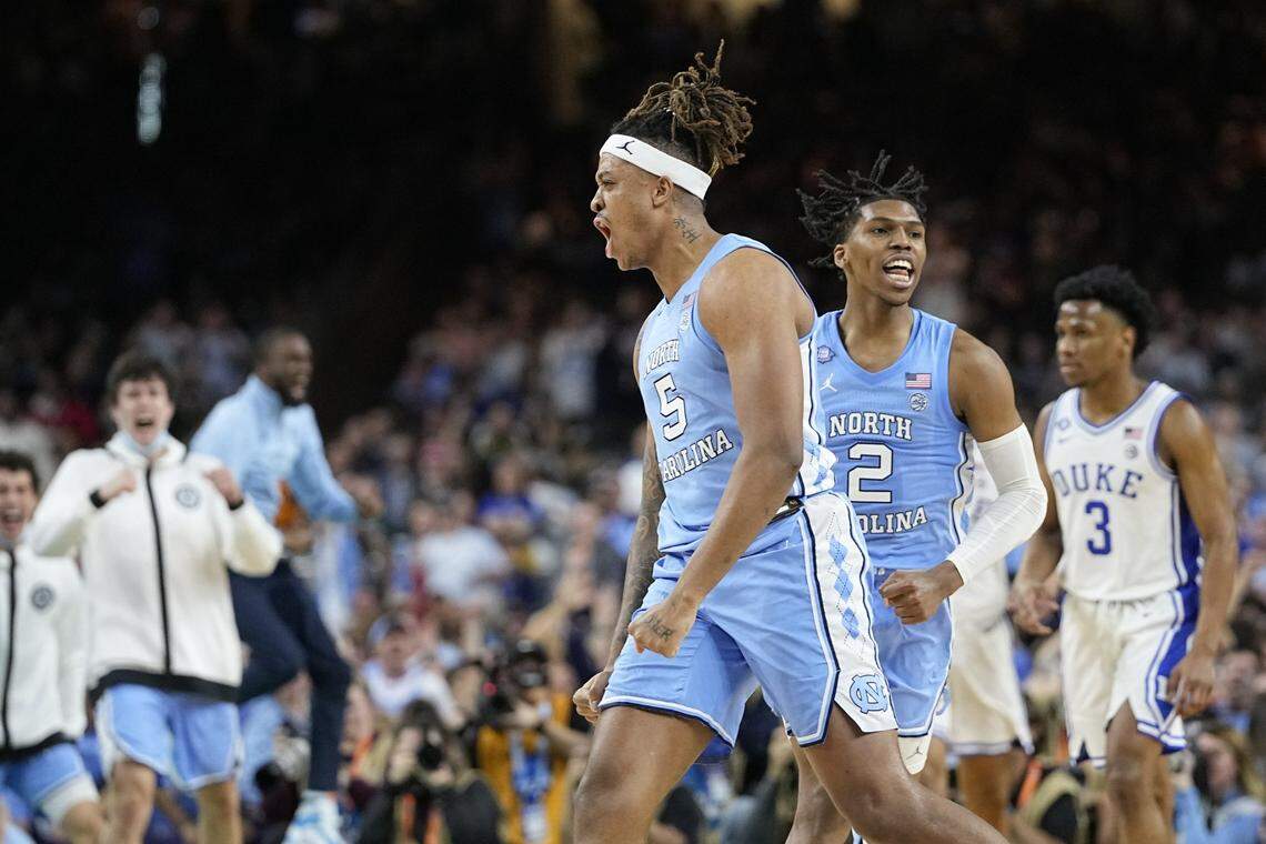 North Carolina forward Armando Bacot (5) and guard Caleb Love (2) celebrate after a score during the second half of a college basketball game against Duke in the semifinal round of the Men’s Final Four NCAA tournament, Saturday, April 2, 2022, in New Orleans. (AP Photo/David J. Phillip)