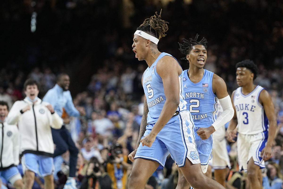 North Carolina forward Armando Bacot (5) and guard Caleb Love (2) celebrate after a score during the second half of a college basketball game against Duke in the semifinal round of the Men’s Final Four NCAA tournament, Saturday, April 2, 2022, in New Orleans. (AP Photo/David J. Phillip)