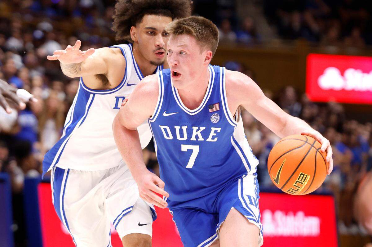 Duke’s Kon Knueppel (7) drives by Tyrese Proctor (5) during a scrimmage during the Blue Devils’ Countdown to Craziness at Cameron Indoor Stadium in Durham, N.C., Friday, Oct. 4, 2024.