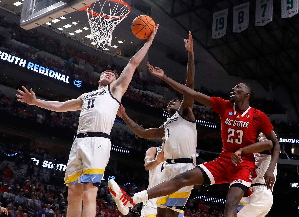 N.C. State’s Mohamed Diarra battles for a rebound with Marquette’s Tyler Kolek and Kam Jones during the first half of the Wolfpack’s 67-58 win in the NCAA Tournament Sweet 16 on Friday, March 29, 2024, at American Airlines Center in Dallas, Texas.