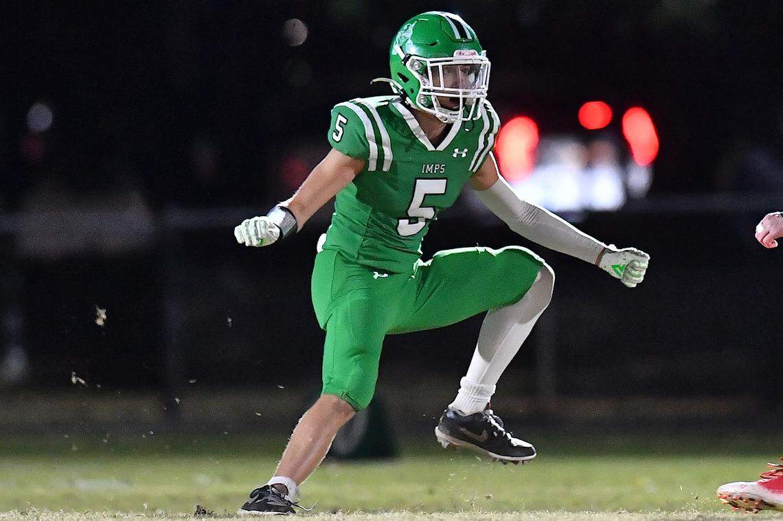 Cary's Erich Grena (5) moves into position to block the defense from Middle Creek during the first half. The Cary Imps and the Middle Creek Mustangs met in a conference football game in Cary, N.C. on October 24, 2025