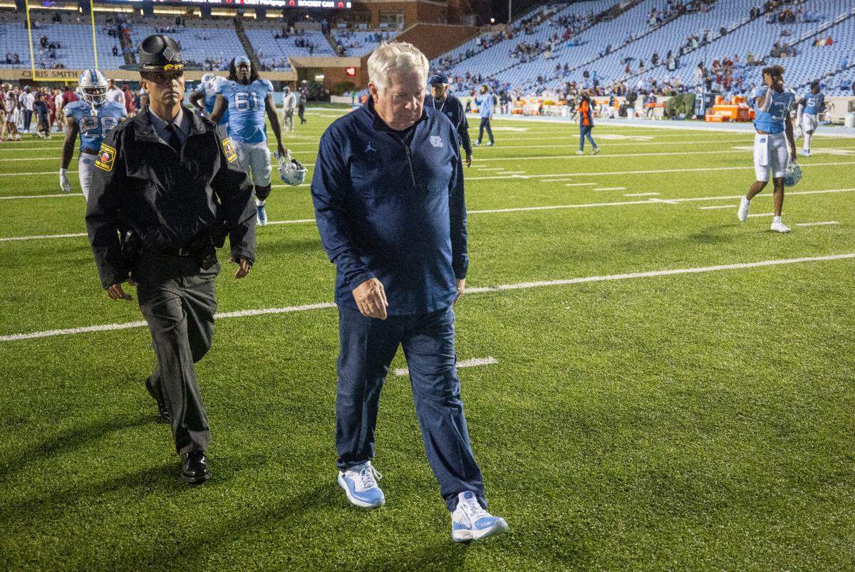 North Carolina coach Mack Brown leave the field following the Tar Heels’ 35-25 loss to Florida State on Saturday, October 9, 2021at Kenan Stadium in Chapel Hill, N.C.