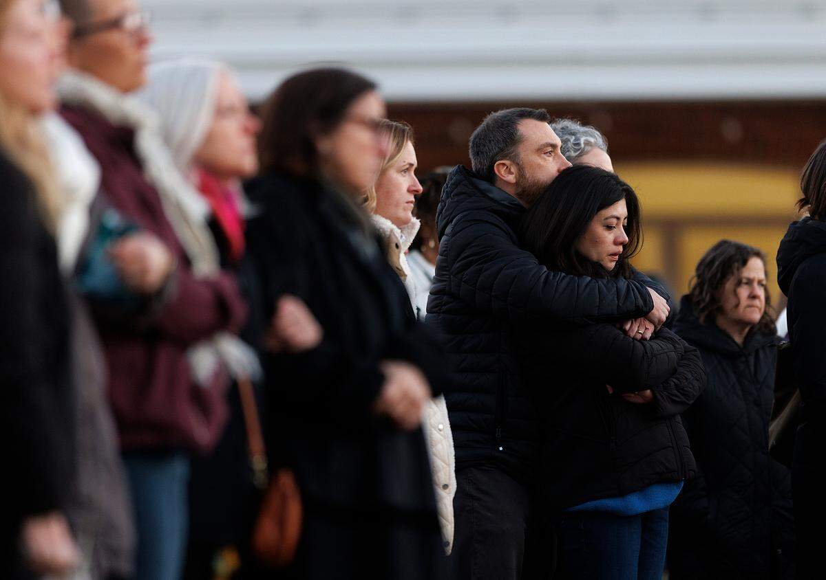 People listen during a vigil held outside the Apex Town Hall on Monday, Jan. 29, 2024, to honor Nancy Taylor and Gabrielle Raymond, who were shot and killed in an Apex neighborhood on Jan. 15.