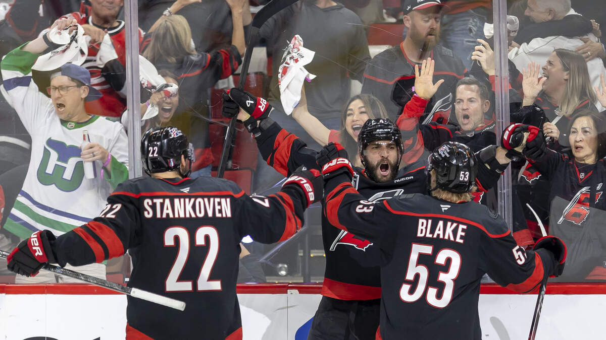 Carolina Hurricanes defenseman Shayne Gostisbehere (4) celebrates with teammates Logan Stankoven (22) and Jackson Blake (53), after scoring to tie Las Vegas 4-4 in the third period of Game 1 in the Stanley Cup Finals, on Tuesday, June 2, 2026 at Lenovo Center in Raleigh, N.C.