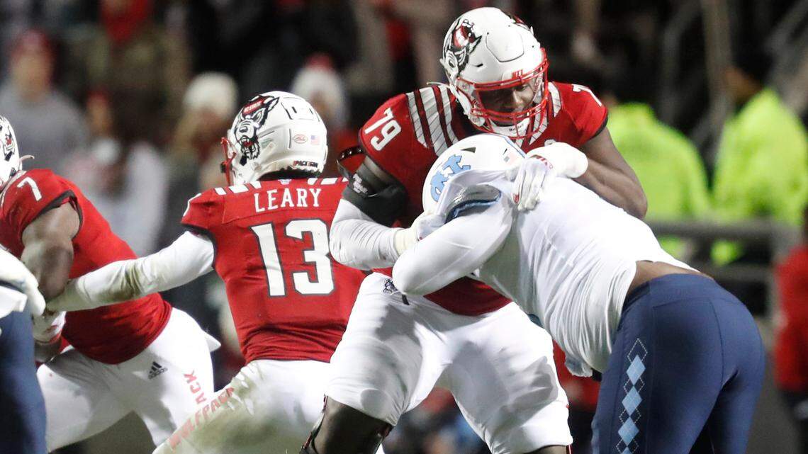 N.C. State offensive tackle Ikem Ekwonu (79) blocks North Carolina defensive lineman Myles Murphy (8) during the first half of N.C. State’s game against UNC at Carter-Finley Stadium in Raleigh, N.C., Friday, November 26, 2021.
