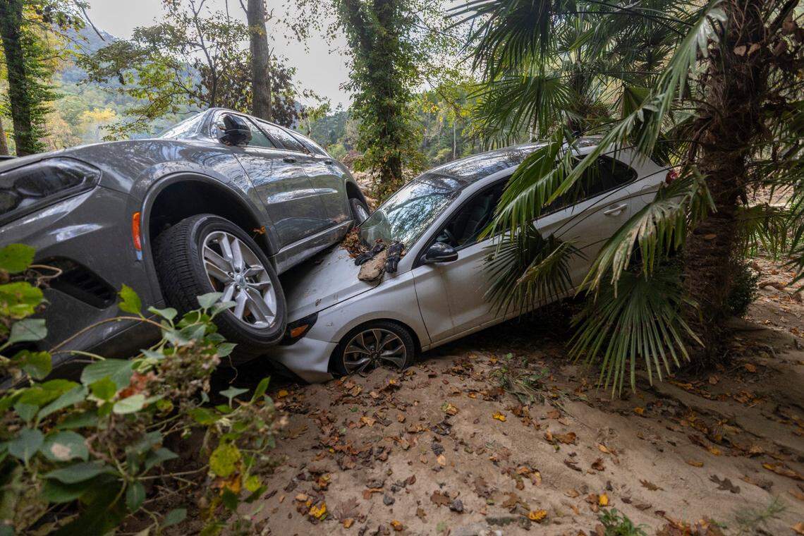 Susan Figetakis and Ernie Planck’s automobiles were tossed atop each other by Hurricane Helene which flooded the Green River on Monday, October 7, 2024 near Saluda, N.C.