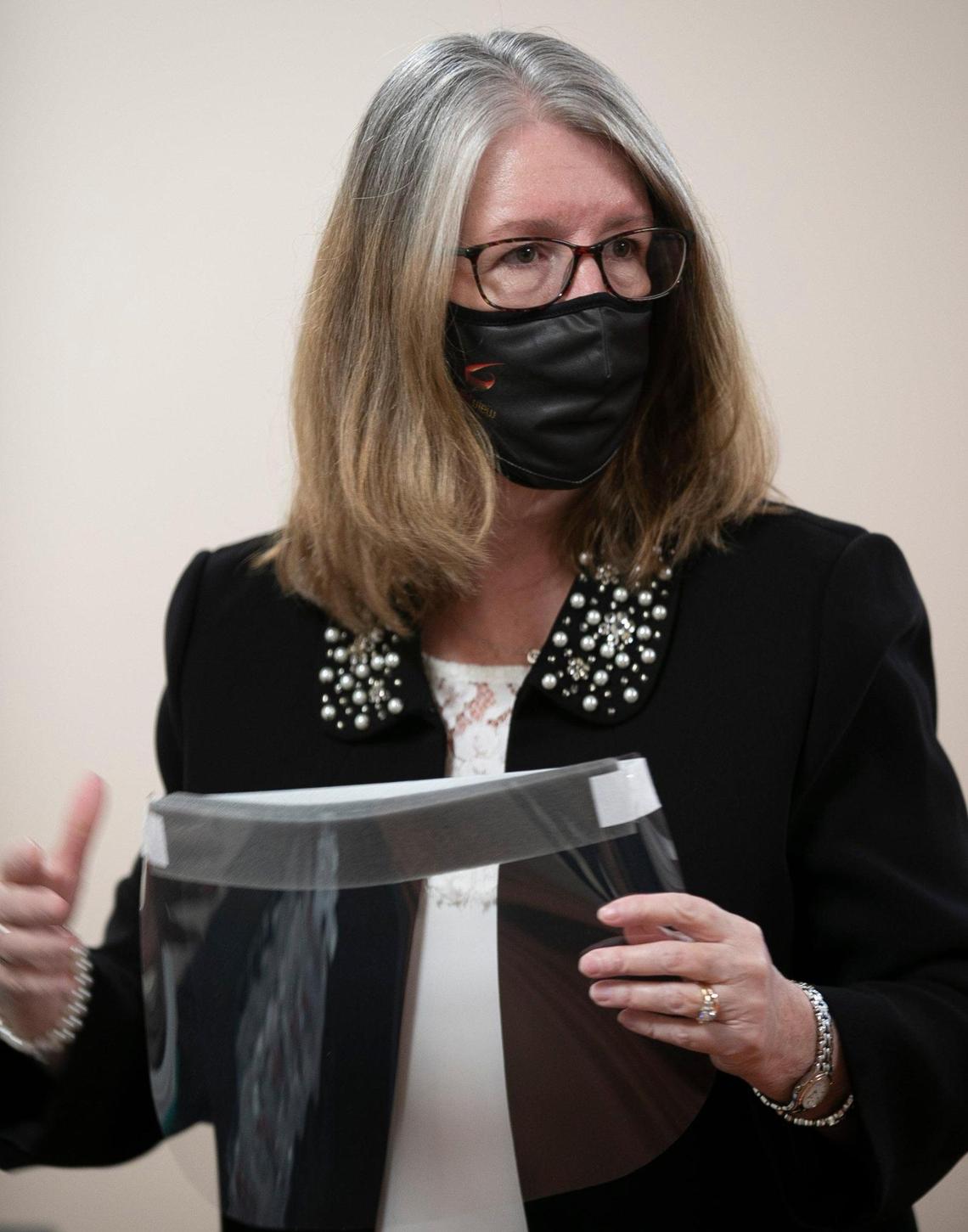 Jennifer Aspell, President of Bright View Technologies shows North Carolina Governor Roy Cooper one of the face shields the company produces on Thursday, November 19, 2020 in Durham, N.C. Bright View Technologies produces optical management products and began producing face shields when the COVID-19 pandemic started.