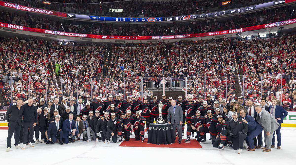 The Carolina Hurricanes surround the Prince of Wales Trophy after defeating Montreal 6-1 to win the East Conference Finals, advancing to play for the Stanley Cup, on Friday, May 29, 2026 at Lenovo Center in Raleigh, N.C.