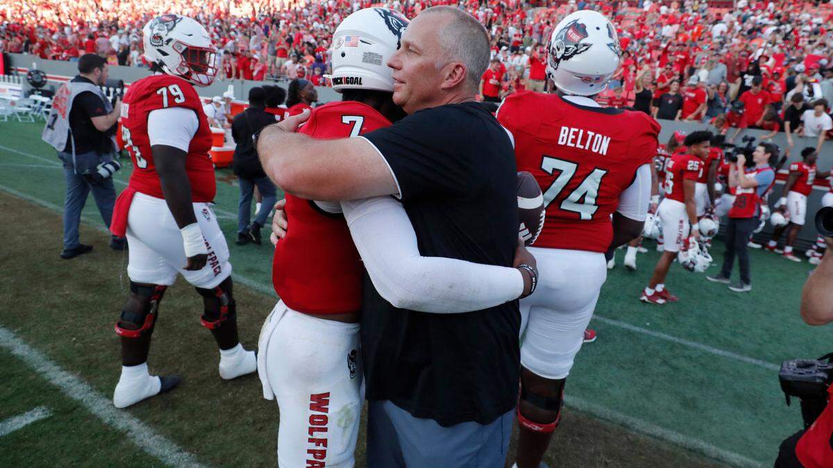 N.C. State head coach Dave Doeren hugs quarterback MJ Morris (7) after the Wolfpack’s 24-17 victory over Clemson at Carter-Finley Stadium in Raleigh, N.C., Saturday, Oct. 28, 2023.