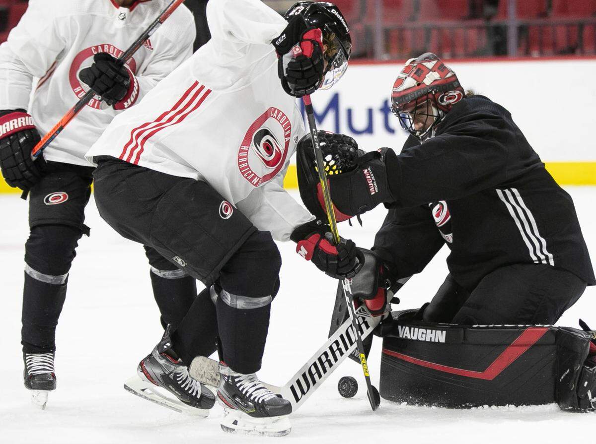 Carolina Hurricanes goalie Alex Nedeljkovic (39) stops a shot attempt by Brock McGinn (23) during practice on Saturday, May 29, 2021 at PNC Arena in Raleigh, N.C.
