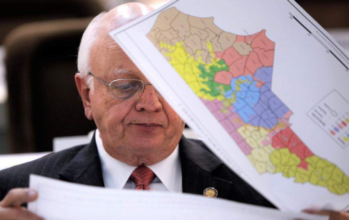 Rep. John Faircloth checks maps during a meeting of joint redistricting committees Monday, Nov. 7, 2011.