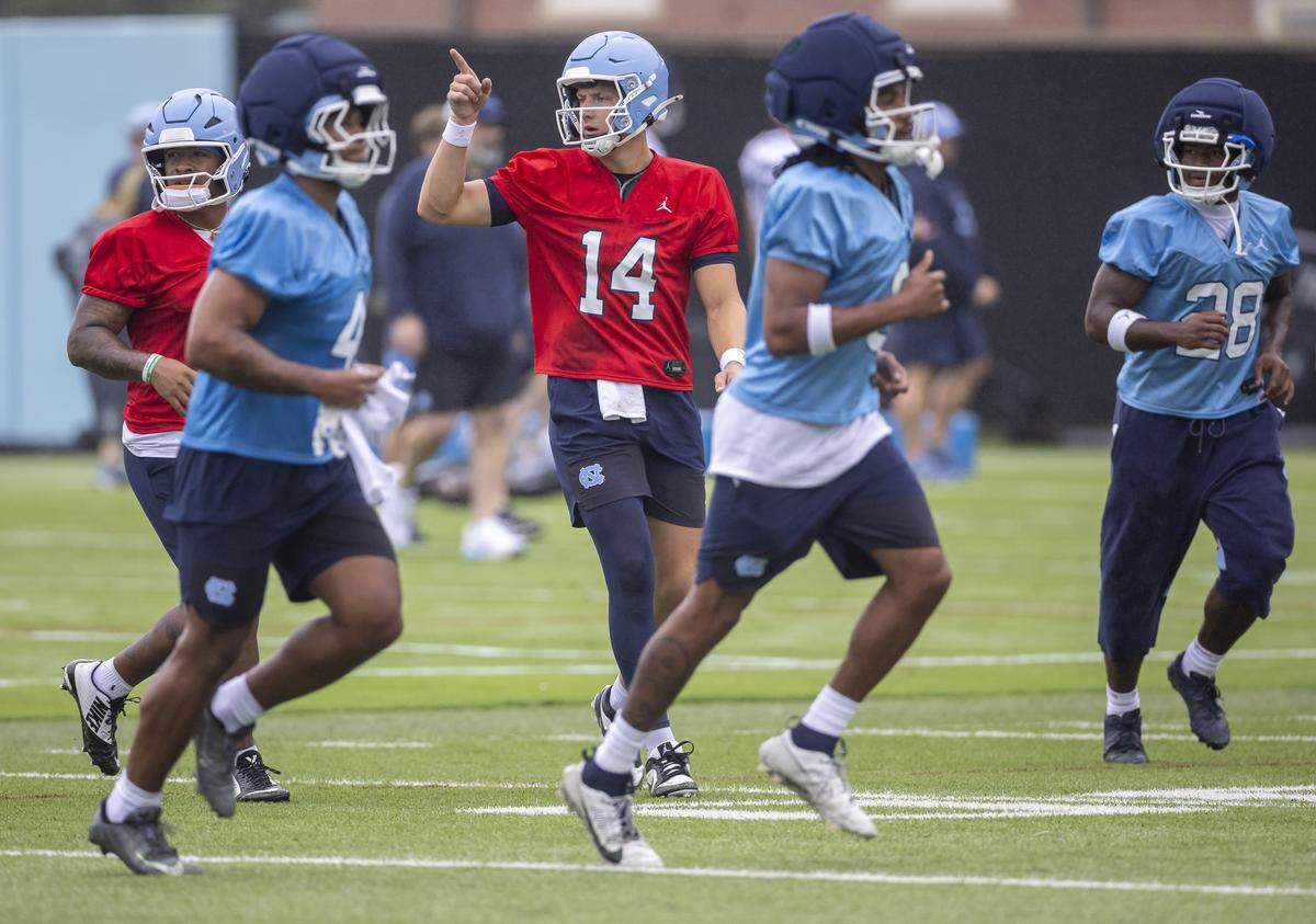 North Carolina quarterback Max Johnson (14) directs teammates to their next drill station during the Tar Heels’ practice on Saturday, Aug. 2, in Chapel Hill.