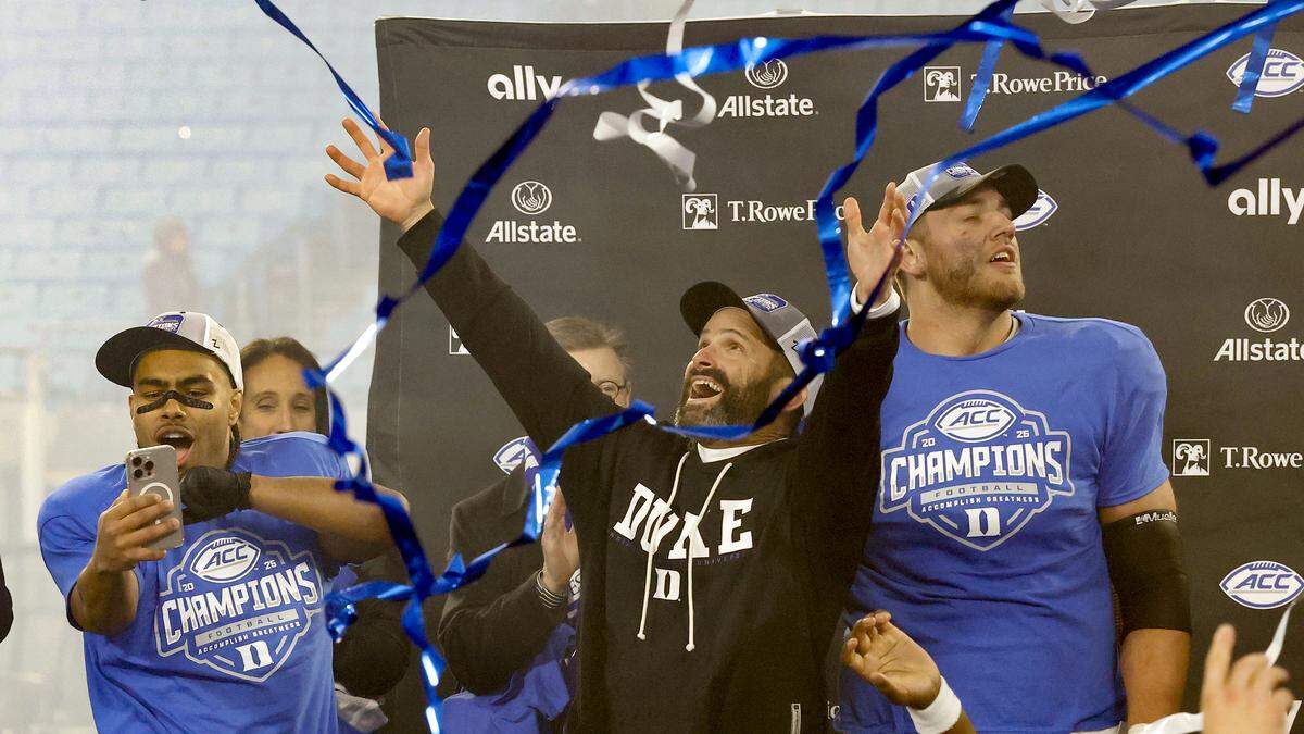 Duke head coach Manny Diaz celebrates as streamers fall following the Blue Devils’ 27-20 overtime victory over Virginia in the ACC Football Championship on Saturday, Dec. 6, 2025, at Bank of America Stadium in Charlotte, N.C.