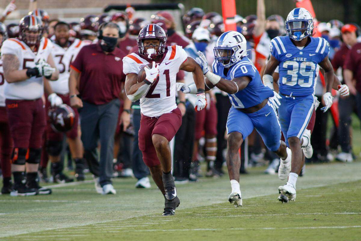 Virginia Tech running back Khalil Herbert (21) breaks free for a first-down run ahead of Duke safety Marquis Waters (0) and cornerback Jeremiah Lewis (39) during the second half of an NCAA college football game Saturday, Oct. 3, 2020, in Durham, N.C. (Nell Redmond/Pool Photo via AP)