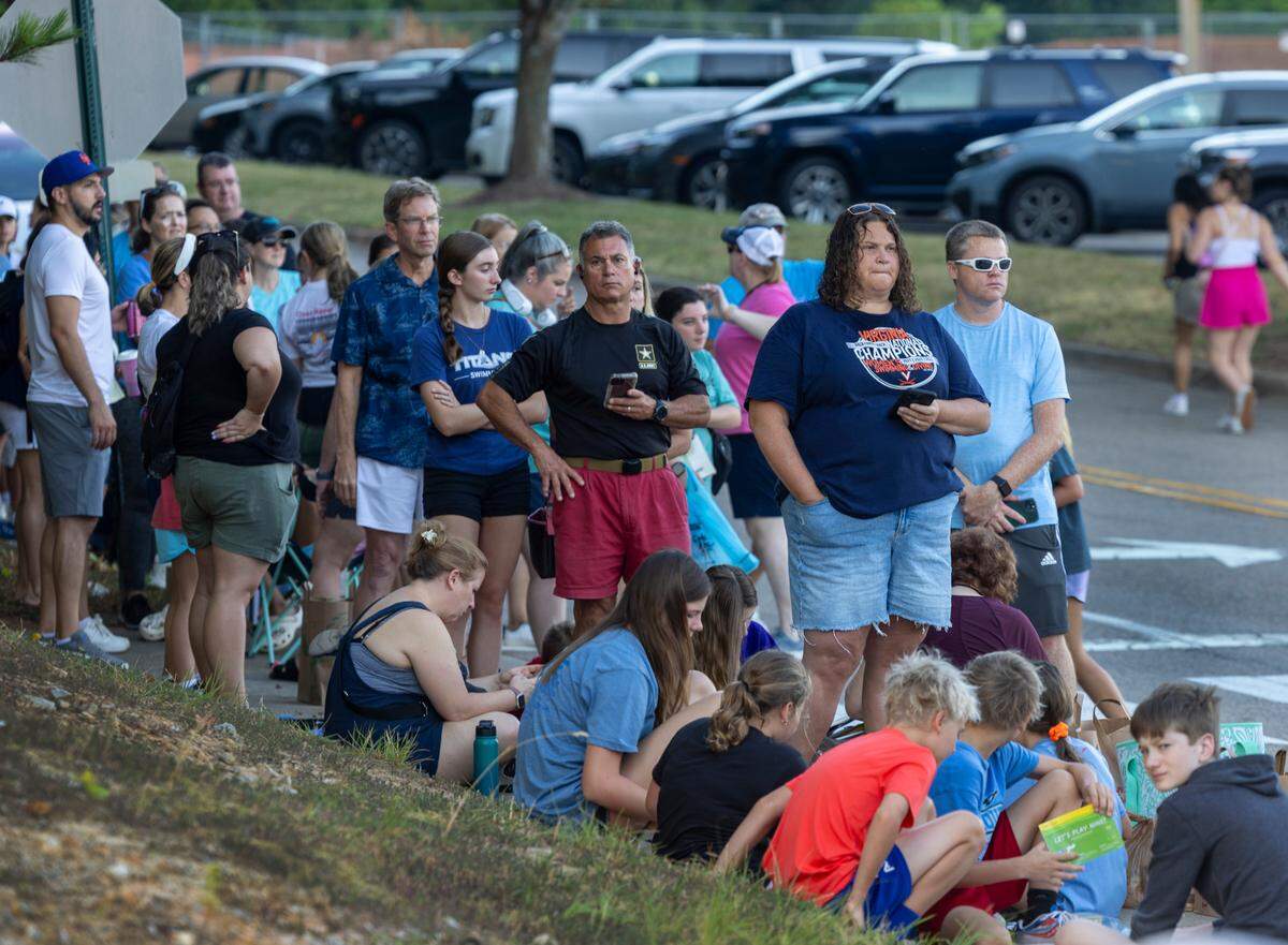 Christi Turner of Cary, N.C. waits in line to enter the Triangle Aquatic Center for the 2024 Olympic Swim team practice on Saturday, July 6, 2024 in Cary, N.C.